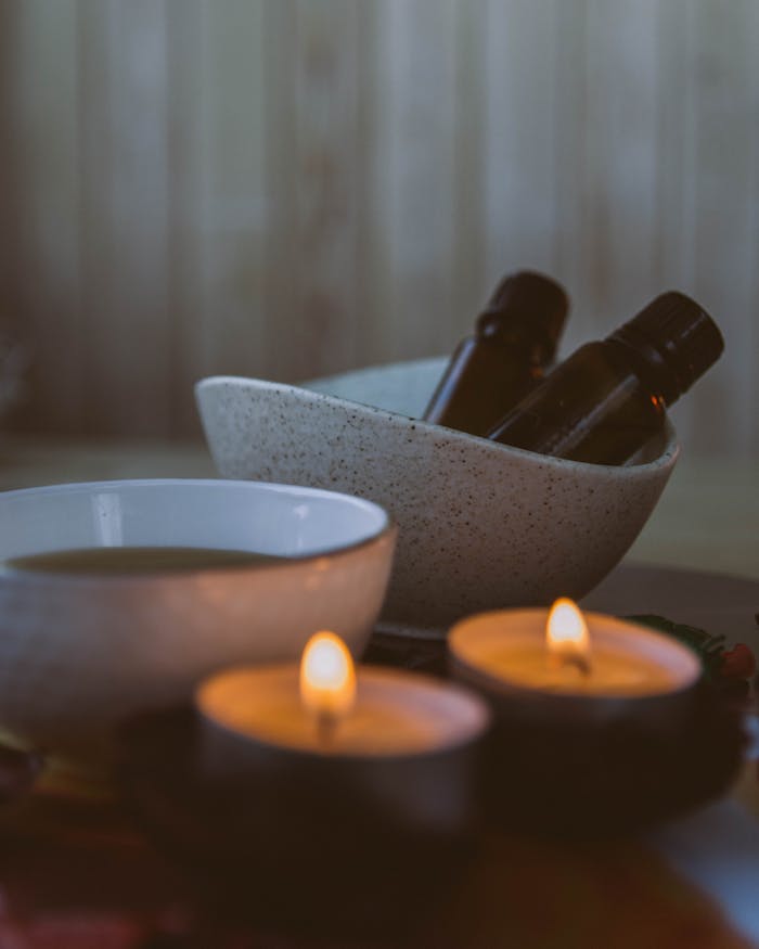 A serene spa setting featuring aromatherapy candles and essential oils, perfect for relaxation.